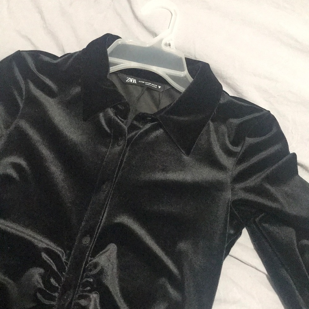 This is a black long sleeve Women’s collar Top with front buttons.